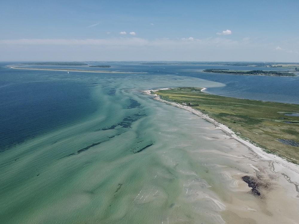 green and blue sea under blue sky during daytime