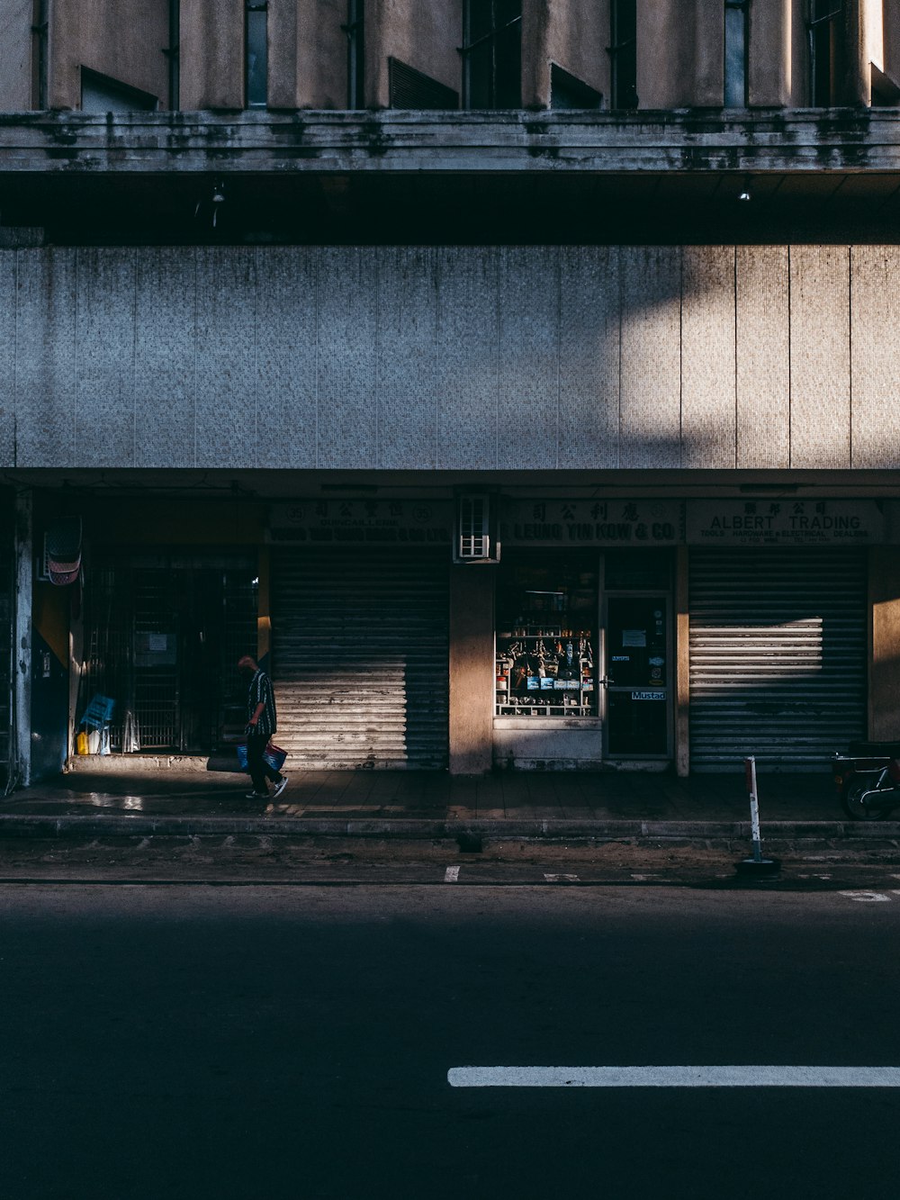 a person sitting on a bench in front of a building