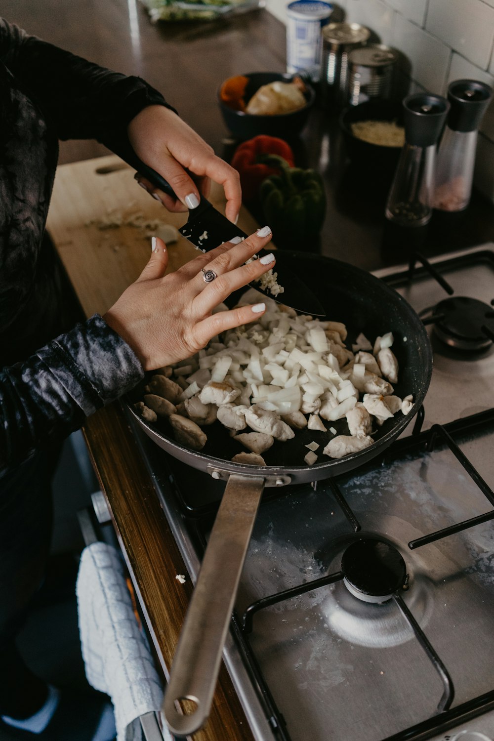 person holding black frying pan with white rice