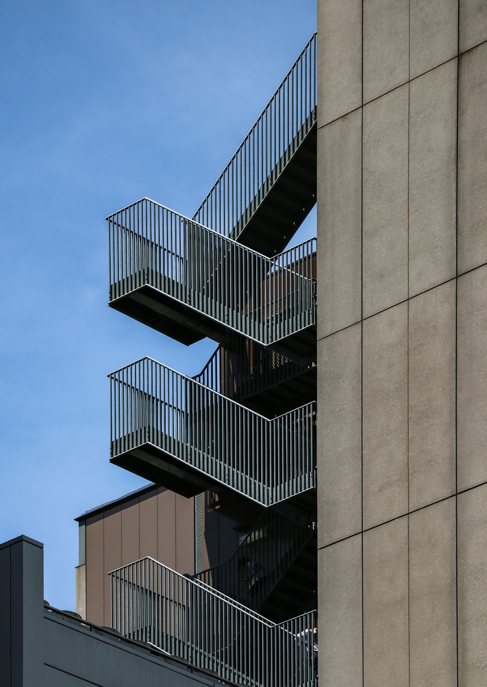 a tall building with a bunch of balconies on top of it