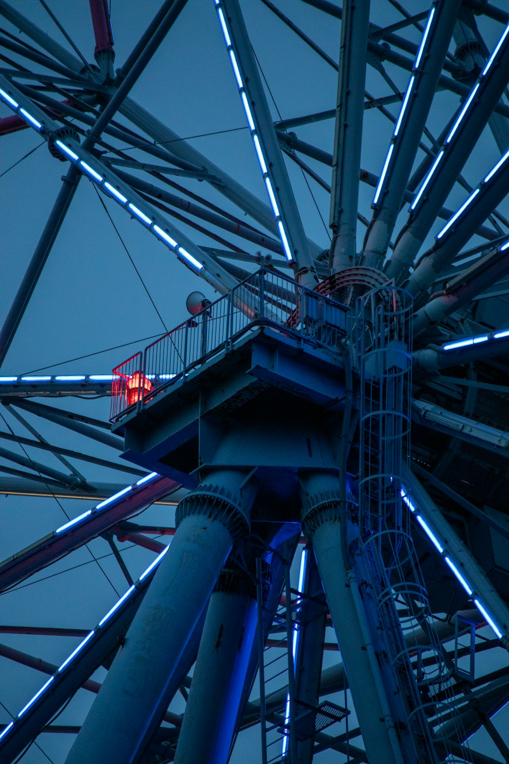 a ferris wheel with a red light on top of it