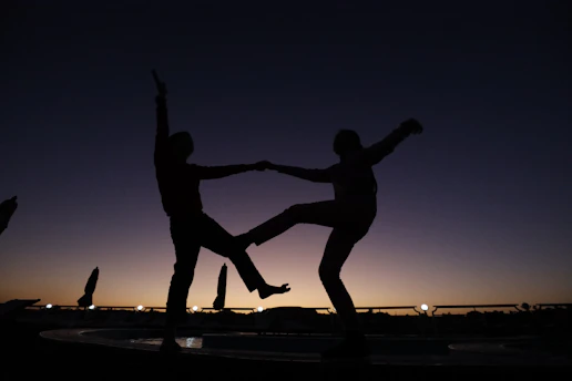 a couple of people standing on top of a fountain