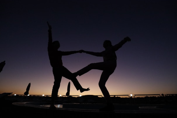 a couple of people standing on top of a fountain