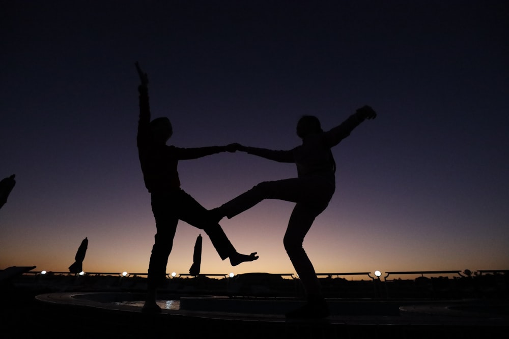 a couple of people standing on top of a fountain