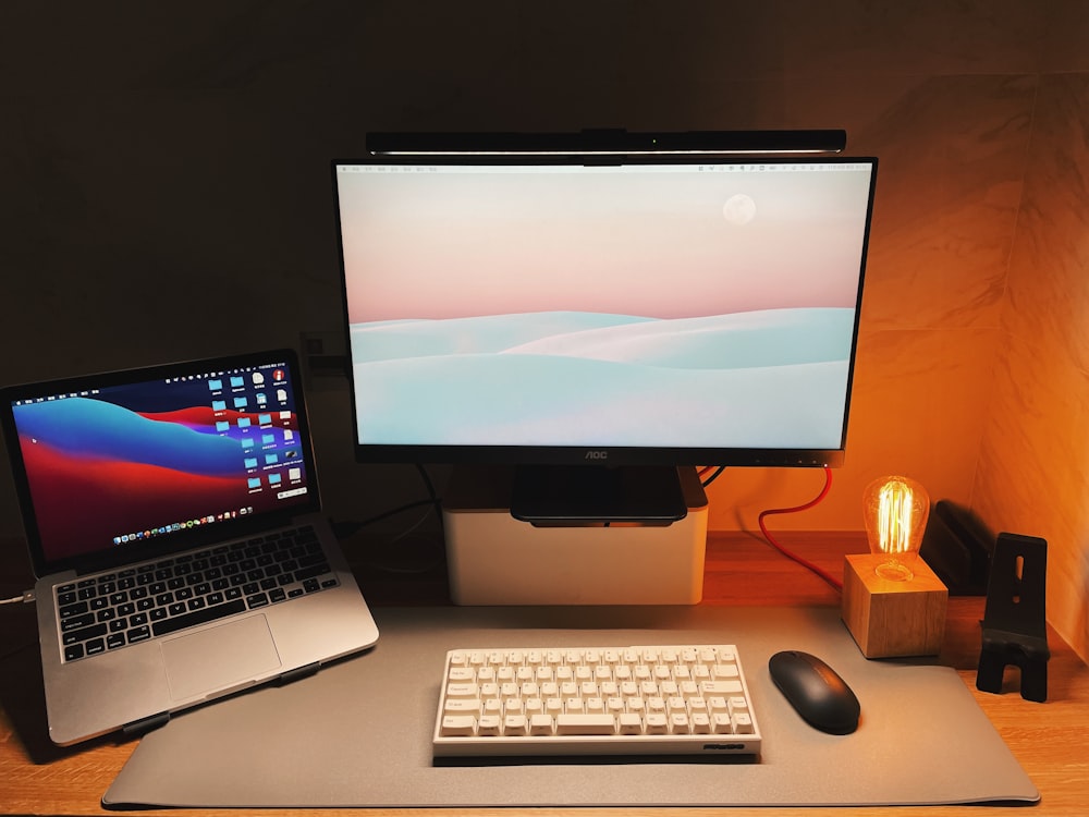 a desk with a laptop and a computer monitor