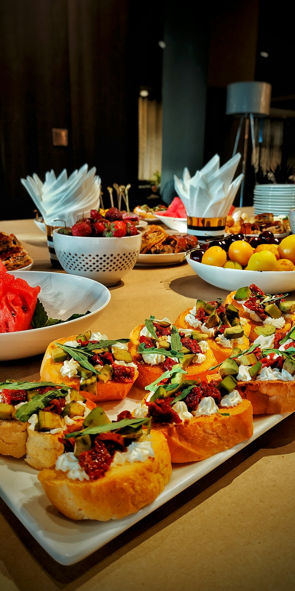 a table topped with plates of food and bowls of fruit