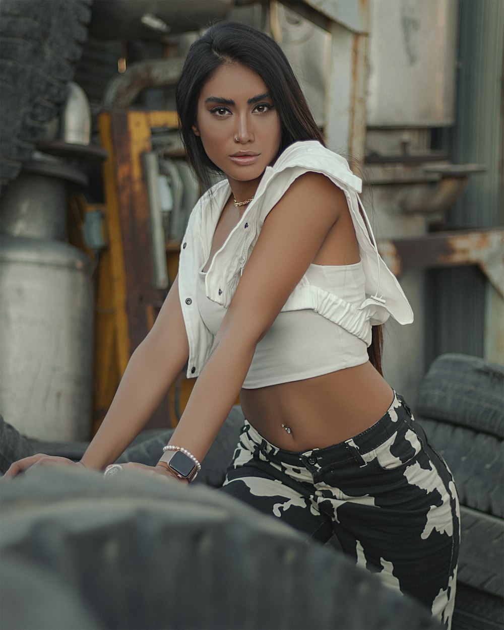 a woman in a white shirt and black and white pants