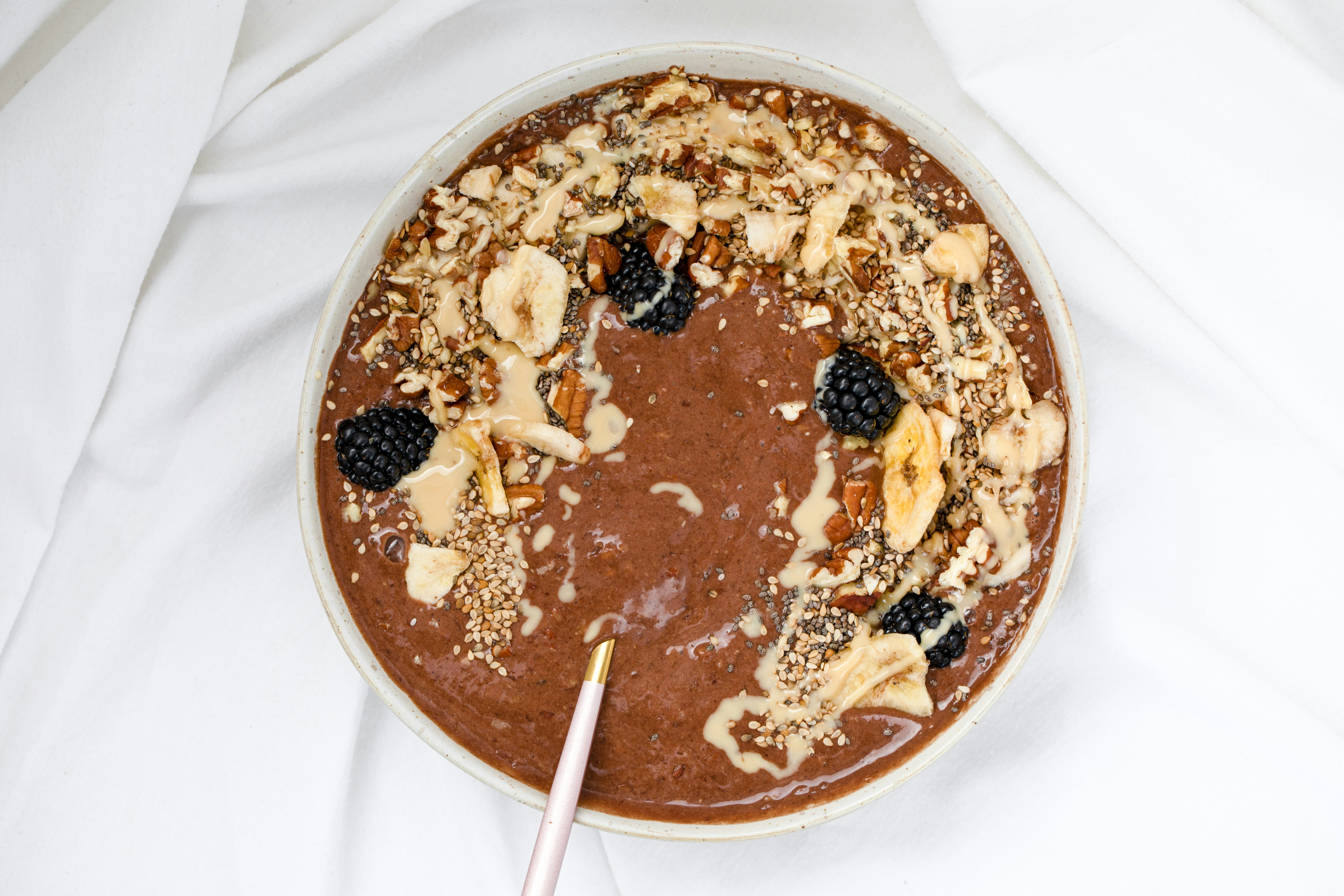 Healthy Chocolate nicecream bowl with nut butter and seeds