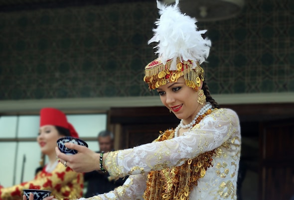 a woman in a white and gold costume