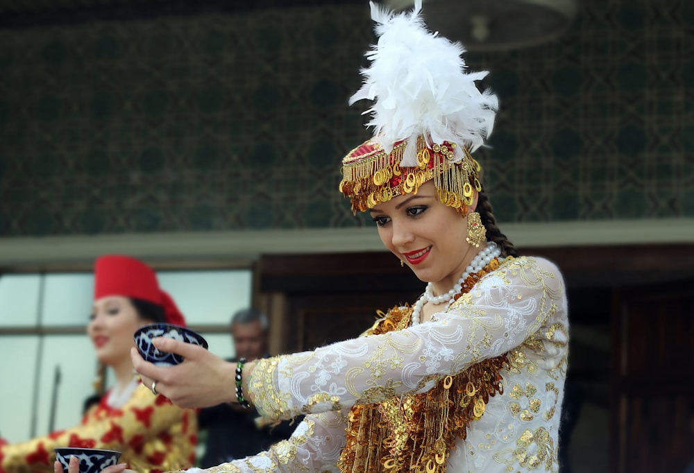 a woman in a white and gold costume