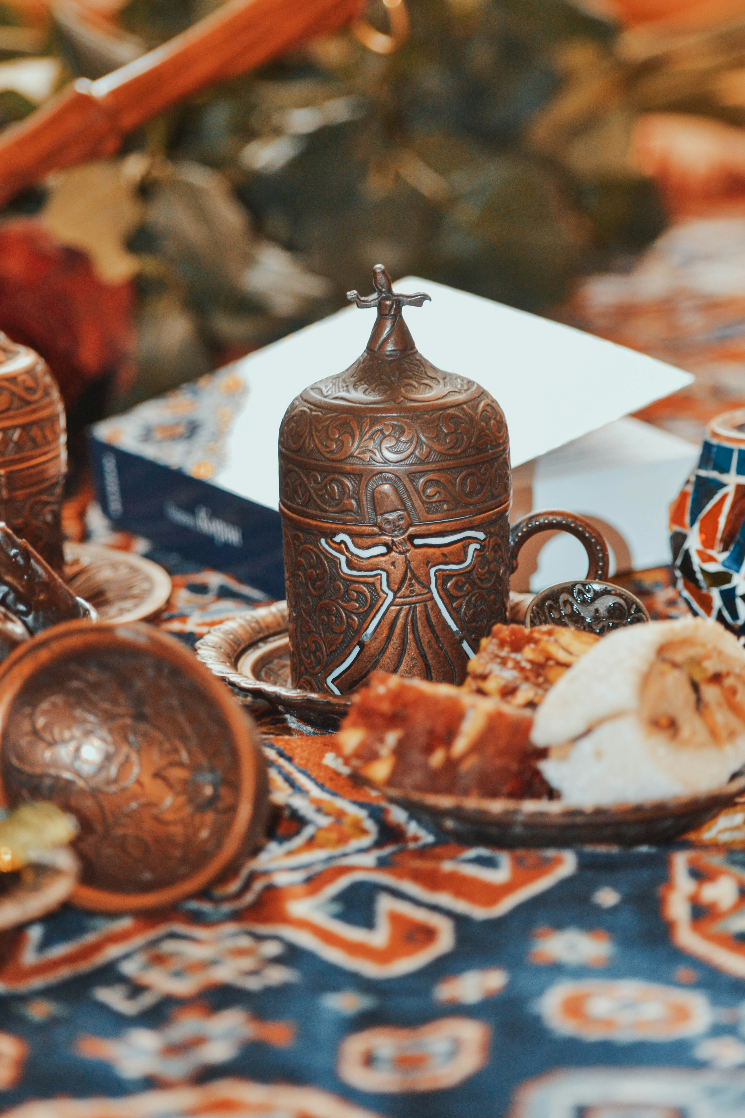 a table topped with a plate of food and a vase