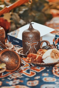 a table topped with a plate of food and a vase