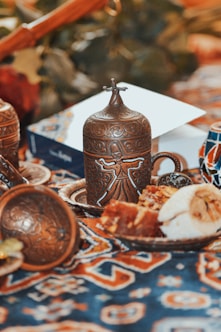 a table topped with a plate of food and a vase
