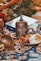 a table topped with a plate of food and a vase
