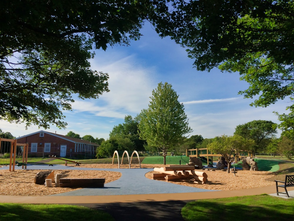 a children's play area in a park with a playground in the background