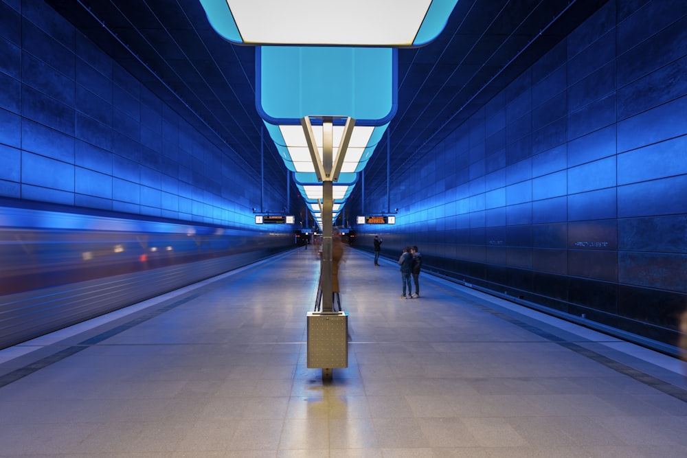 man in black jacket walking on hallway