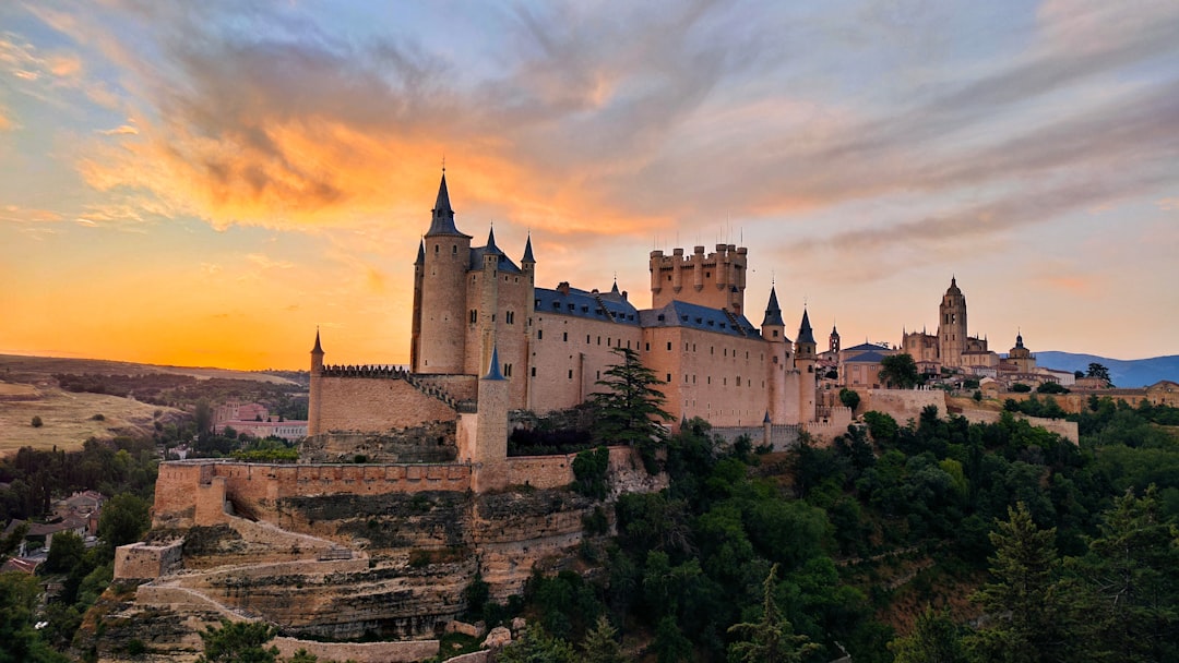 a castle sits on top of a cliff, Amanecer en Segovia