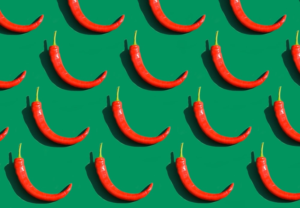 a group of red peppers on a green background