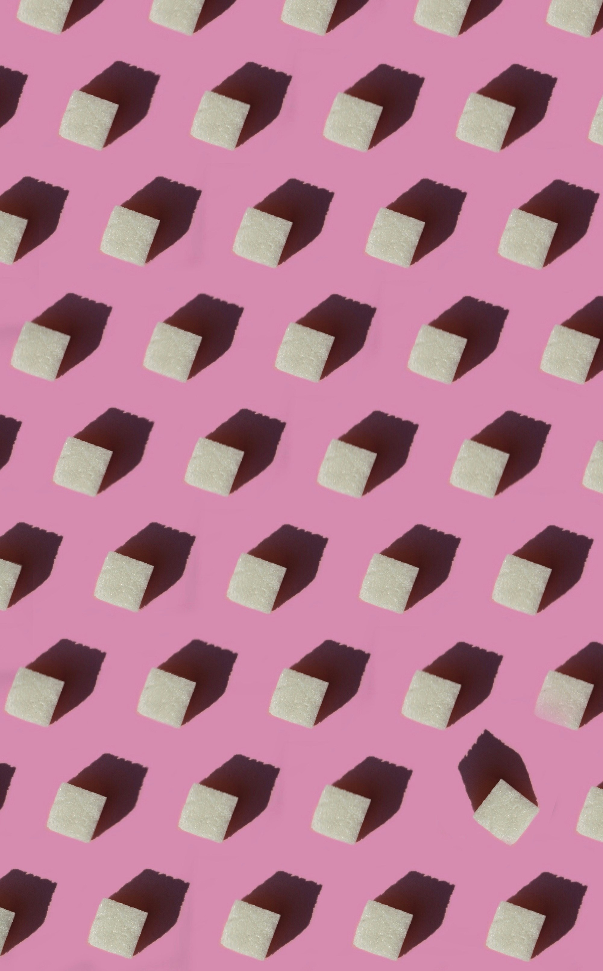 a pink background with a pattern of white blocks