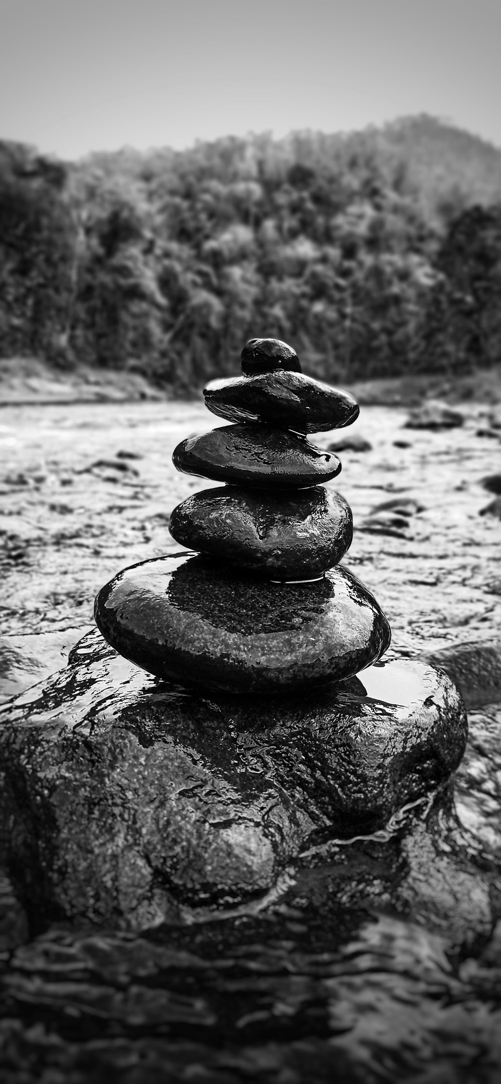 a stack of rocks sitting on top of a river