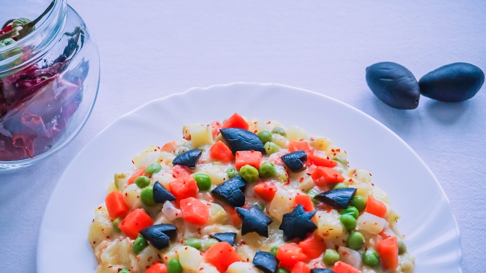 a white plate topped with pasta and veggies