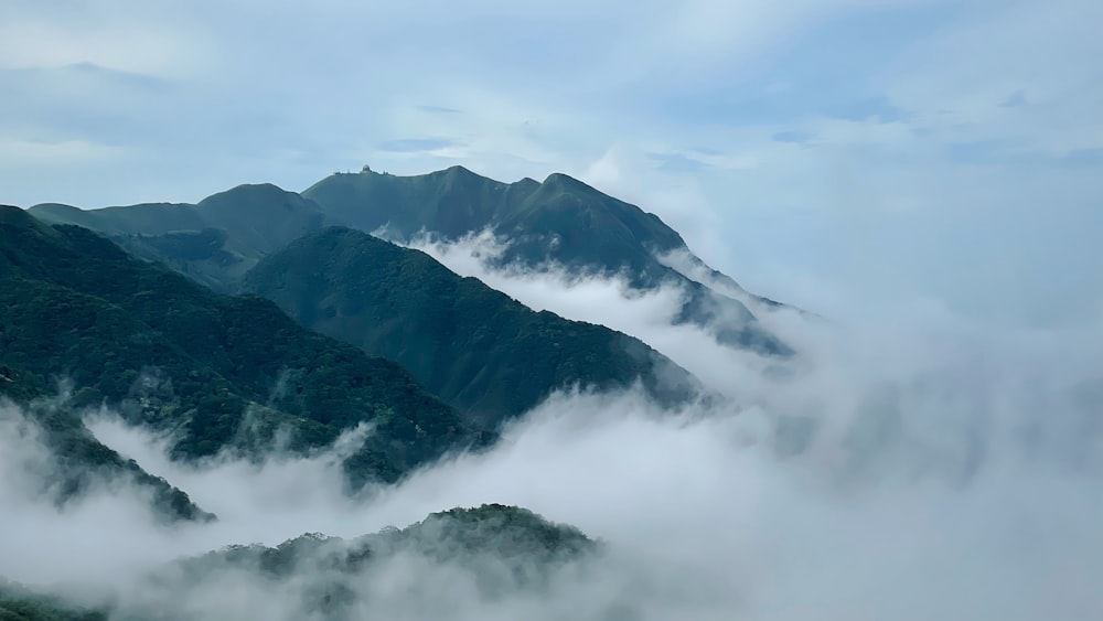 a view of a mountain range covered in clouds