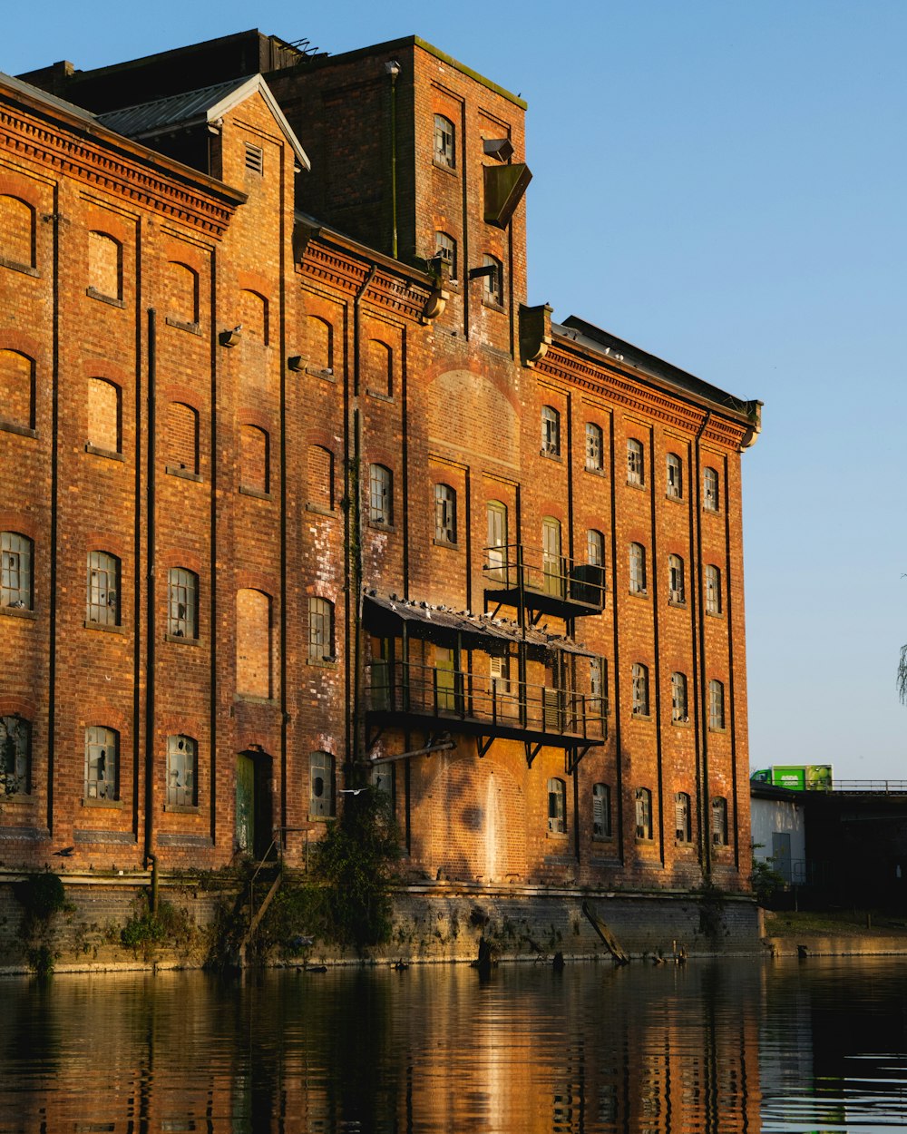 a large brick building sitting next to a body of water