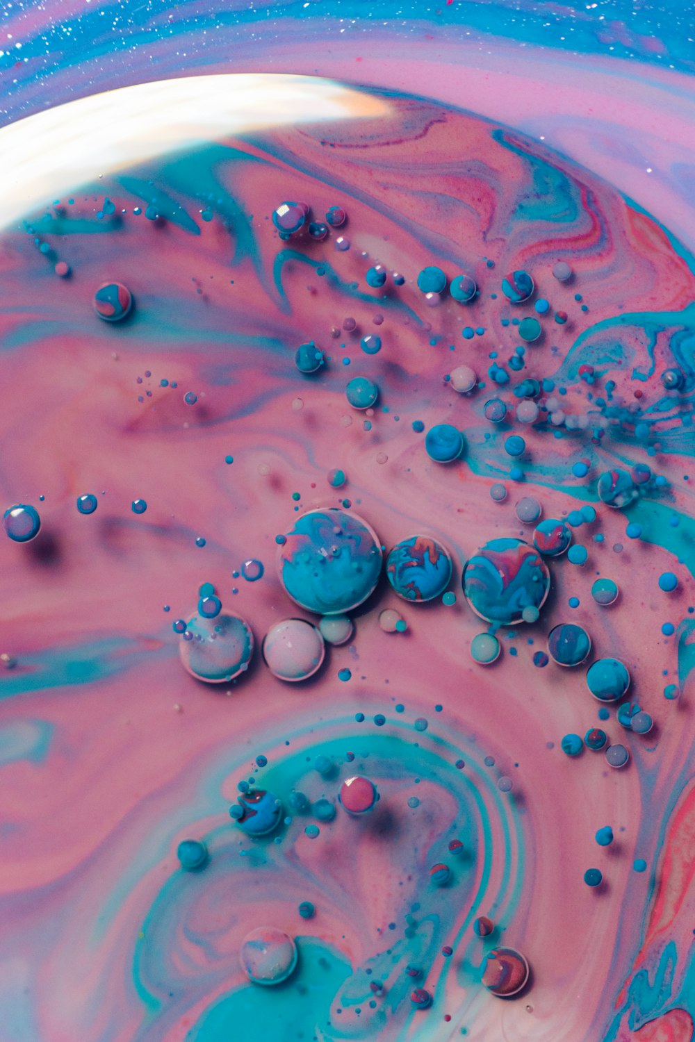 a close up of a blue and pink liquid