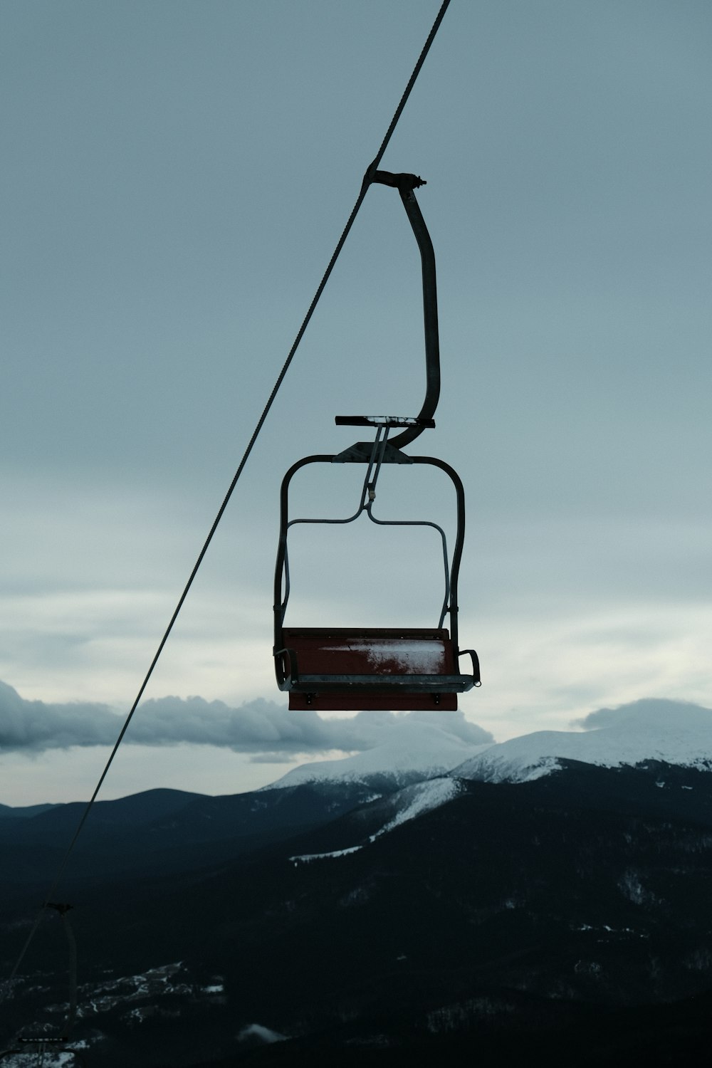 a ski lift going up a snowy mountain