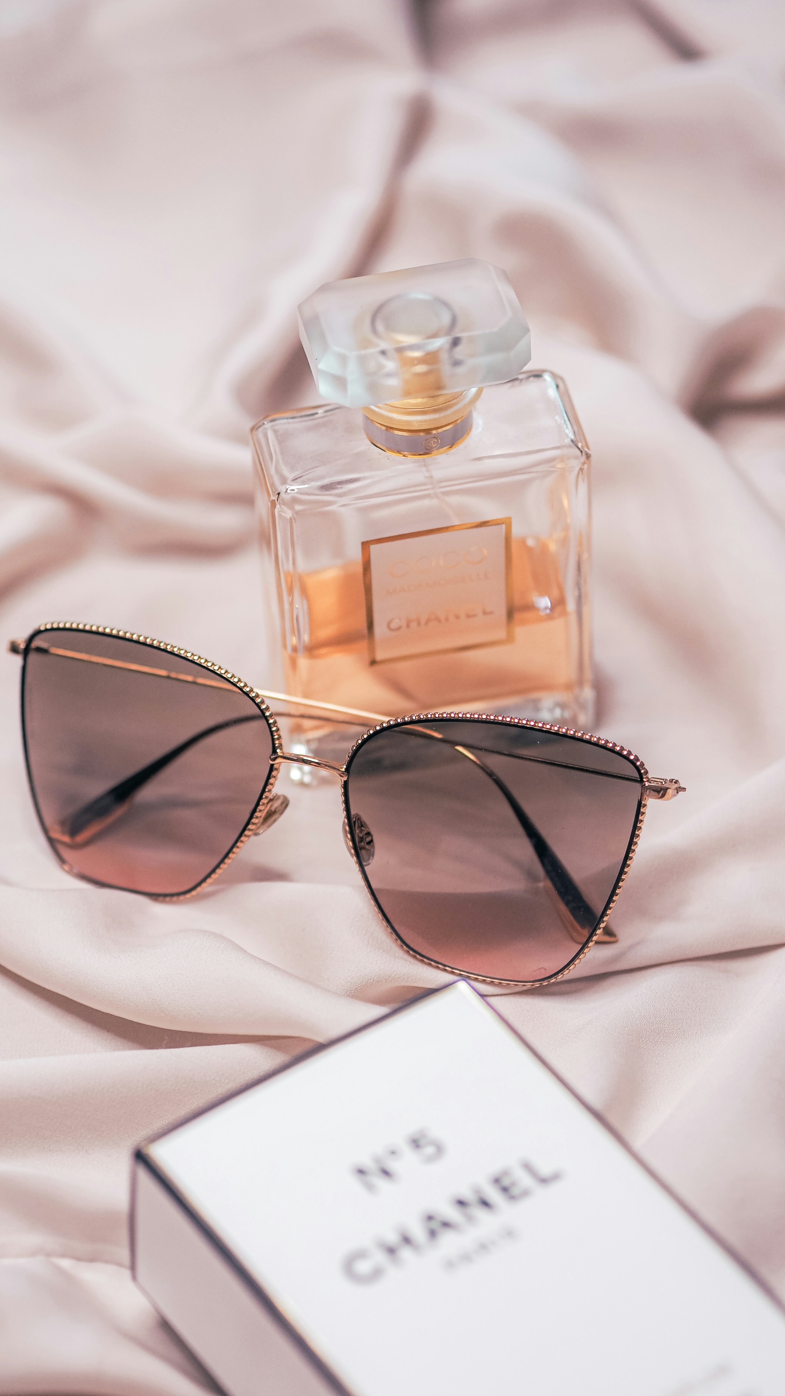 black framed sunglasses on white textile