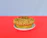 Close-up of a golden-brown high-protein muffin with a soft crumb texture on a rustic wooden table.