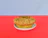 Close-up of a golden-brown high-protein muffin with a soft crumb texture on a rustic wooden table.