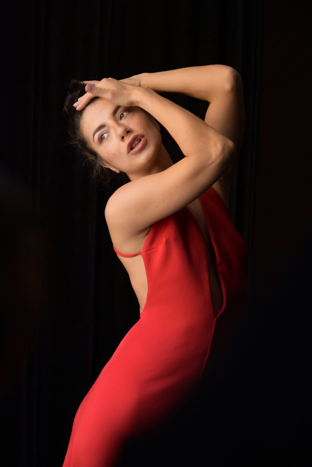 a woman in a red dress posing for a picture