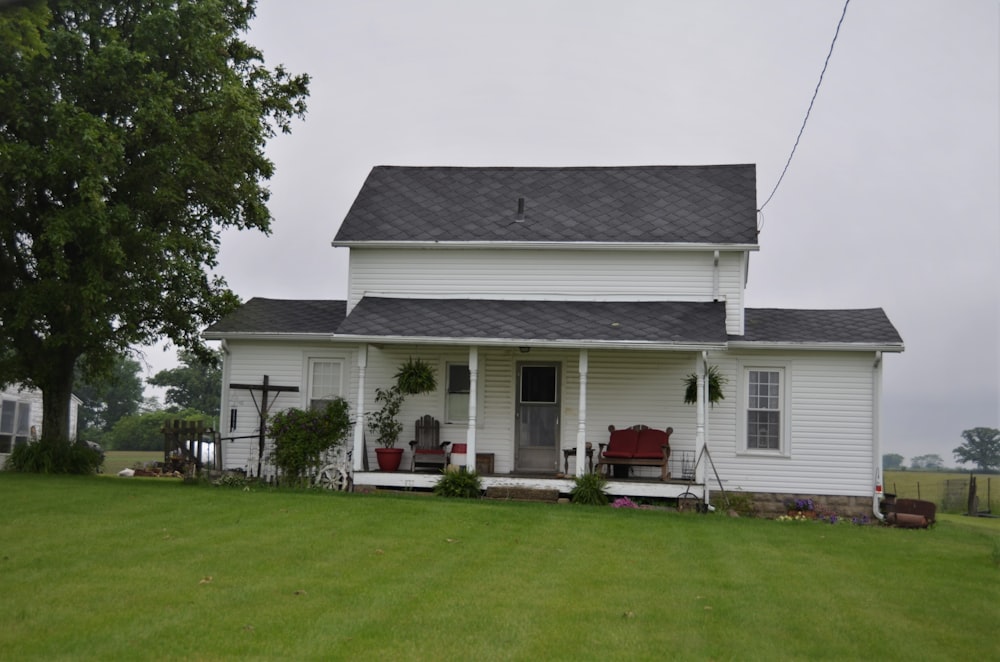 white and gray house near green trees during daytime