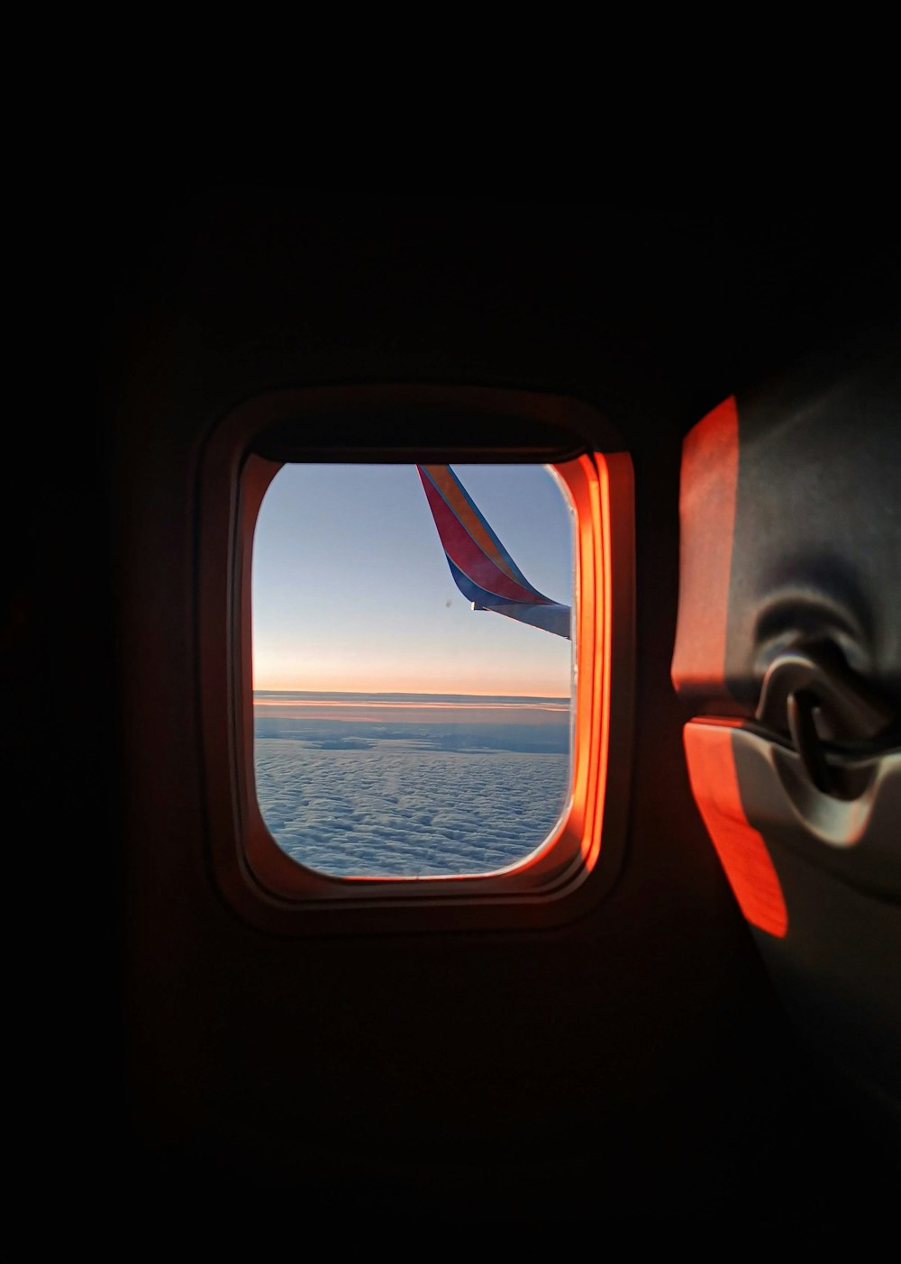 an airplane window with a view of the ocean