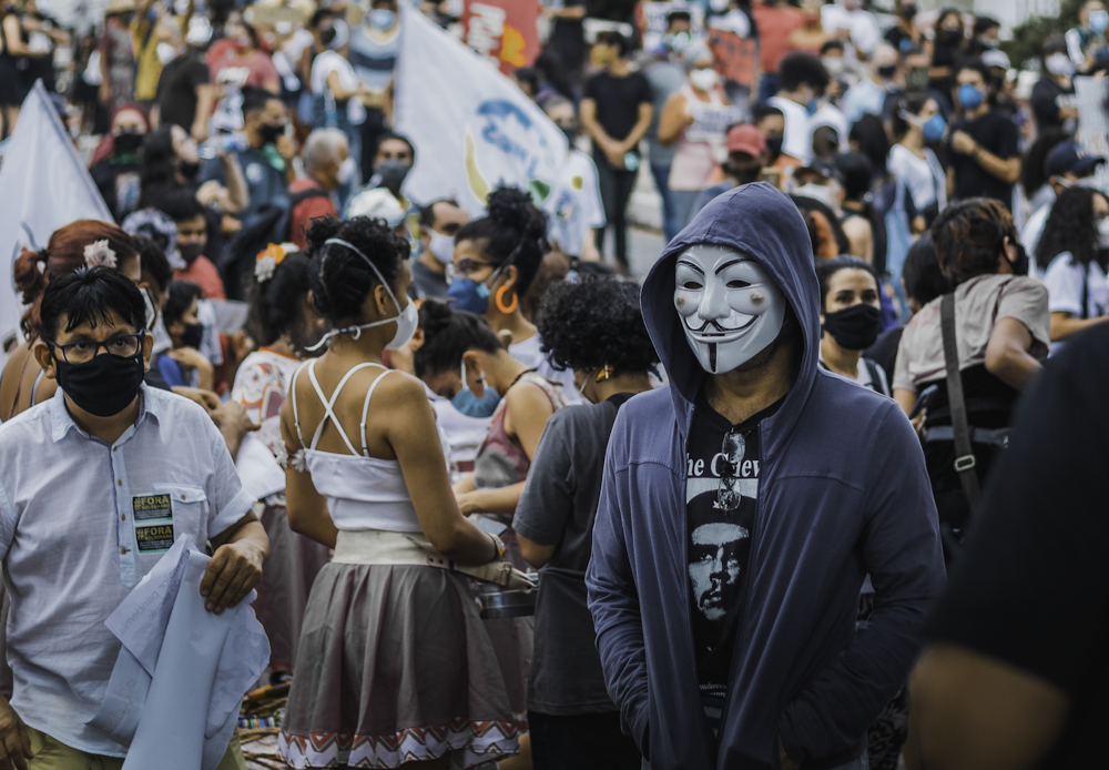 a crowd of people with face paint and masks