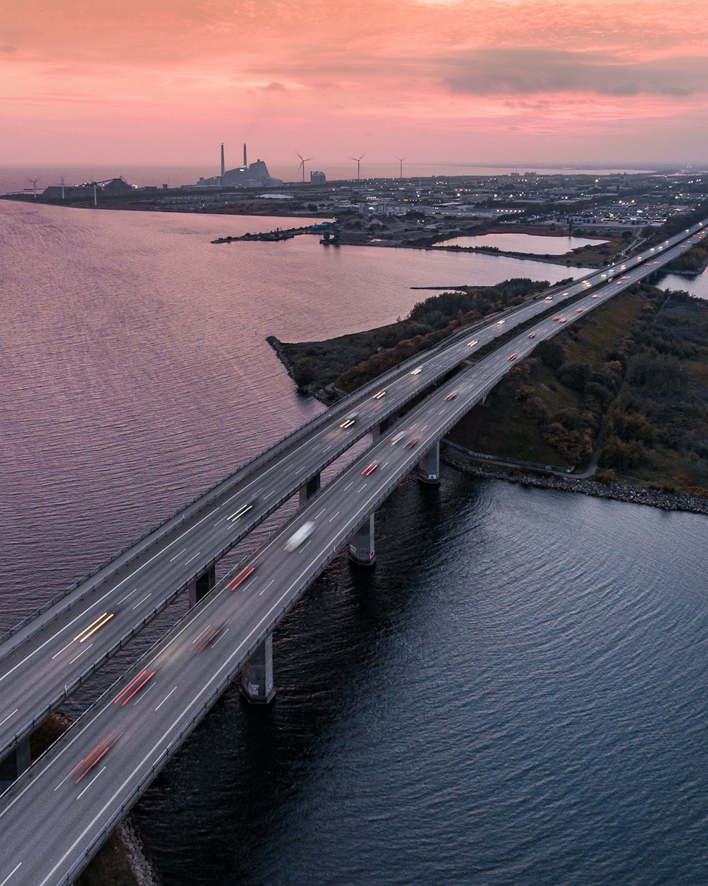 an aerial view of a bridge over a body of water