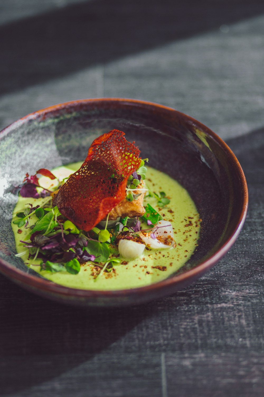 a bowl of food with a garnish on top of it