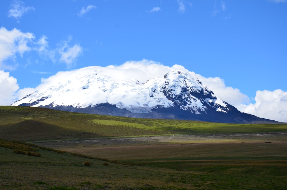 a large snow covered mountain in the distance