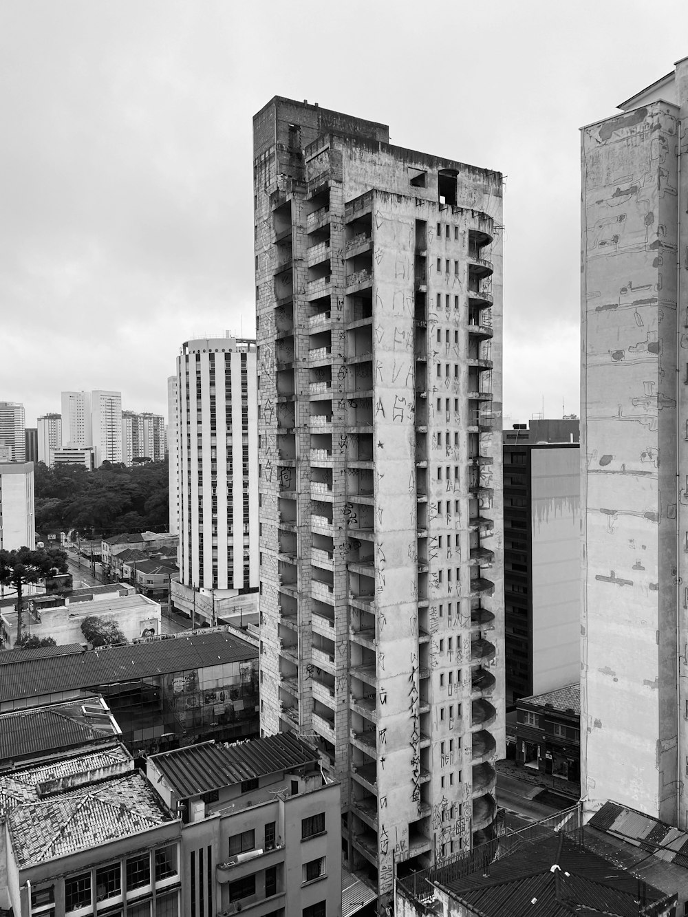 a black and white photo of a city with tall buildings