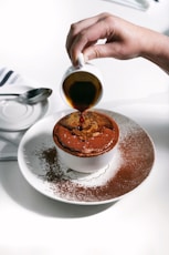 a person pours a cup of coffee into a dessert