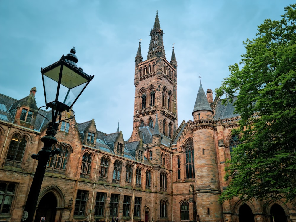 a tall building with a clock tower next to a street light