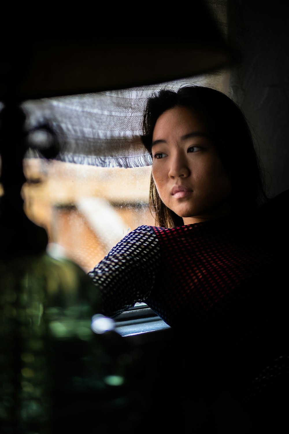 a woman sitting in a car looking out the window