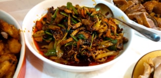 A colorful dinner spread featuring a budget-friendly homemade vegetable stir-fry served in a rustic bowl.