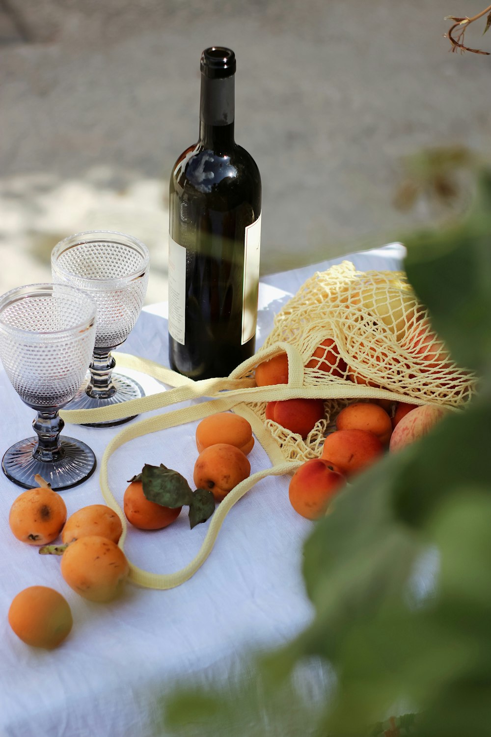 wine bottle beside fruits on table