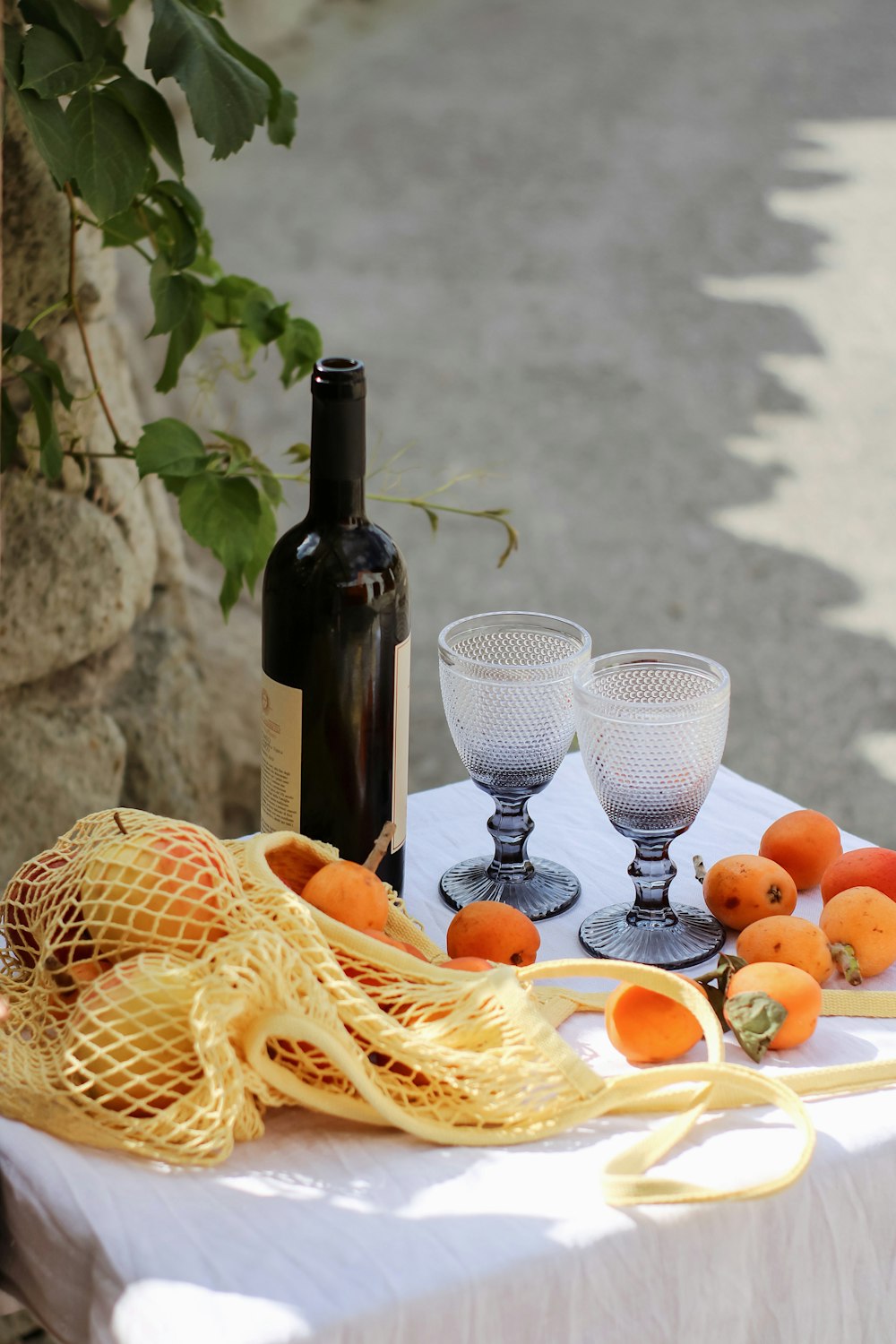 wine bottle beside fruits on table