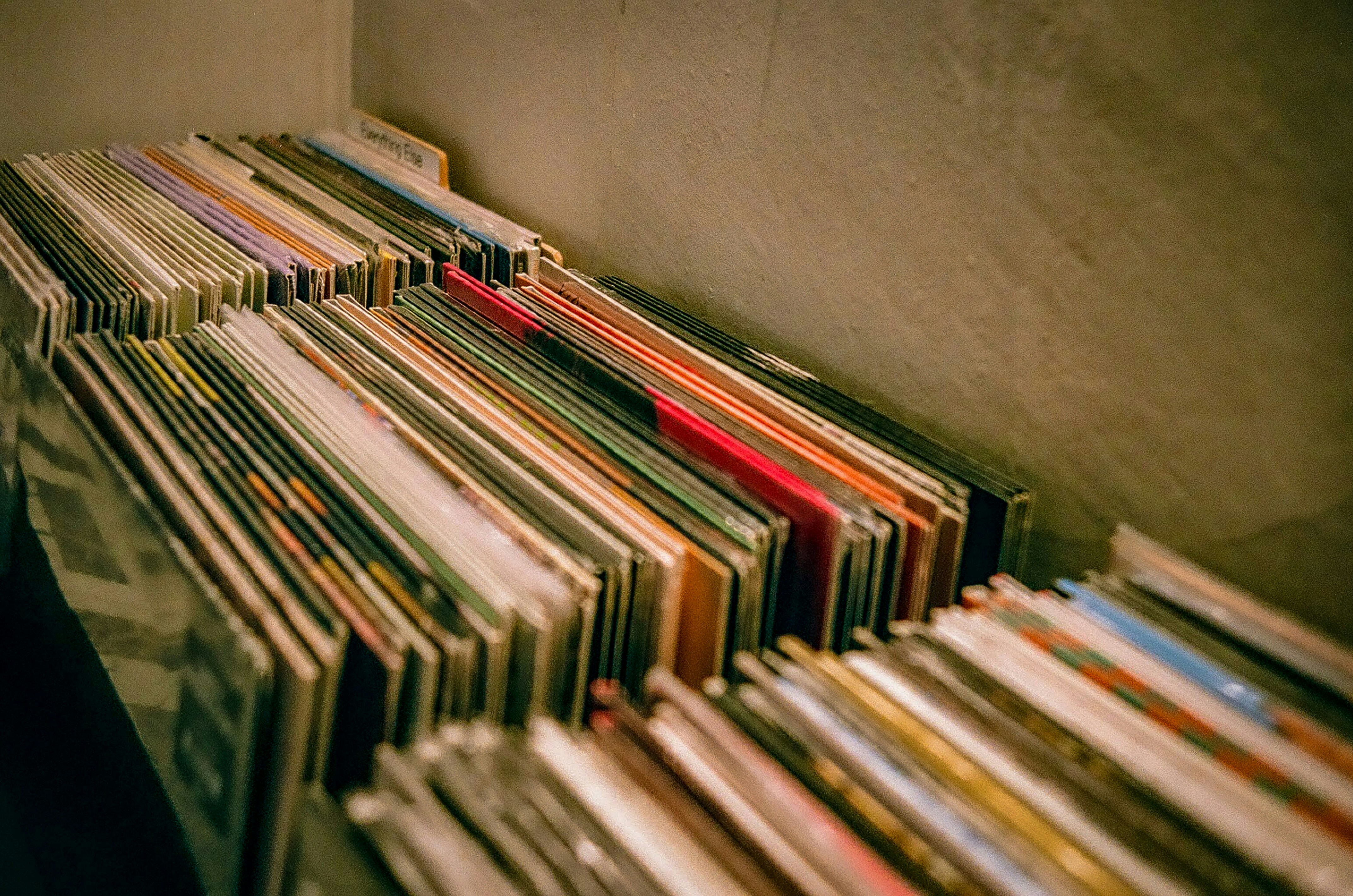 a bunch of records sitting on top of a shelf