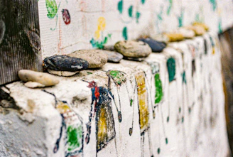 Close-up of a beautifully painted rockwall with intricate patterns in warm earth tones.
