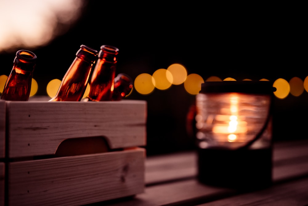 bokeh photography of brown wooden chest box with lighted candle