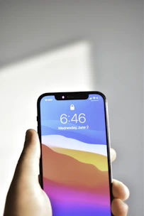 Modern Yuminex smart lock featuring mobile app control displayed on a smartphone screen.